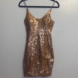 A rose gold sequin-covered mini- cocktail dress in a size medium:))
